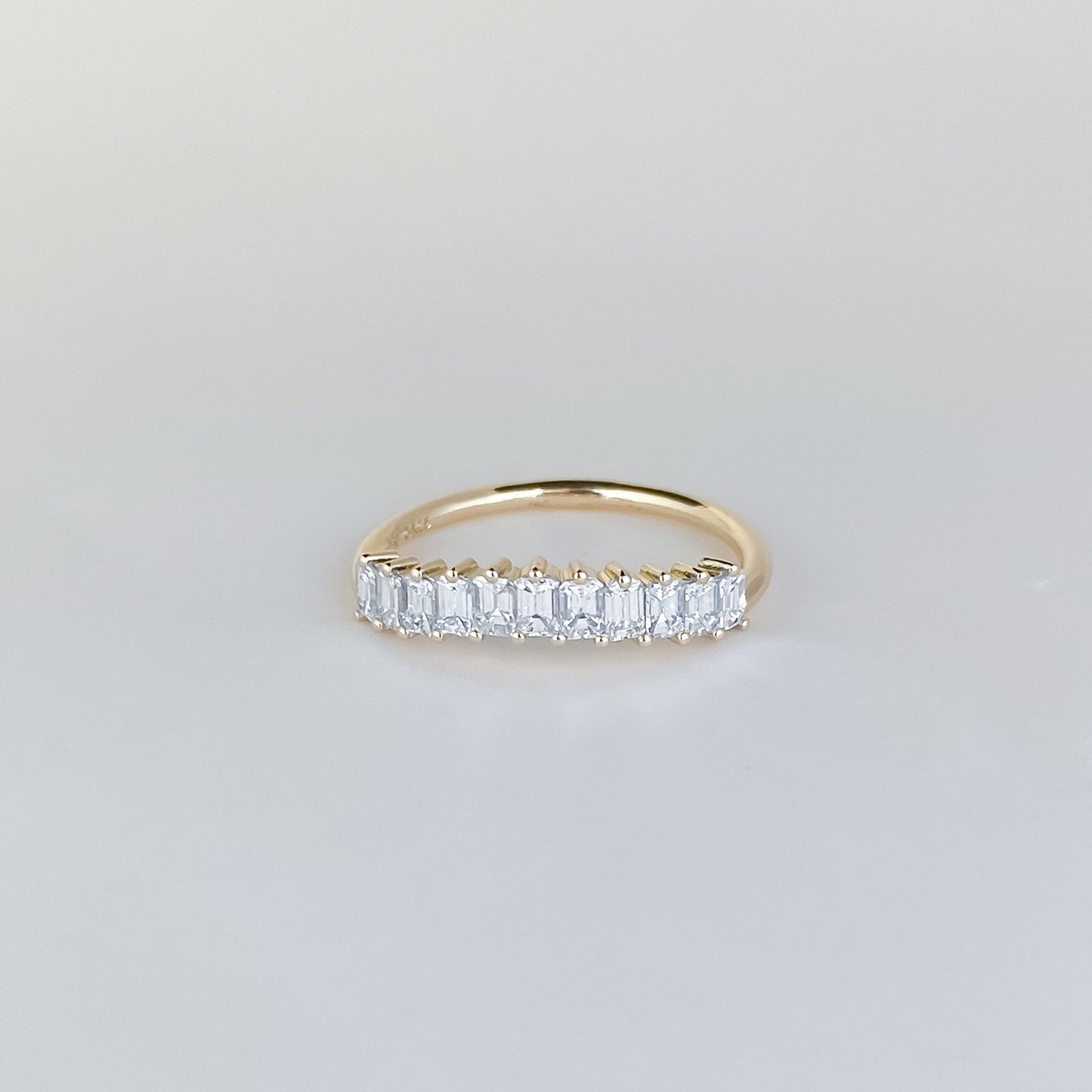 0.68 TCW Emerald Stones Curved Lab Grown Diamond Wedding Band