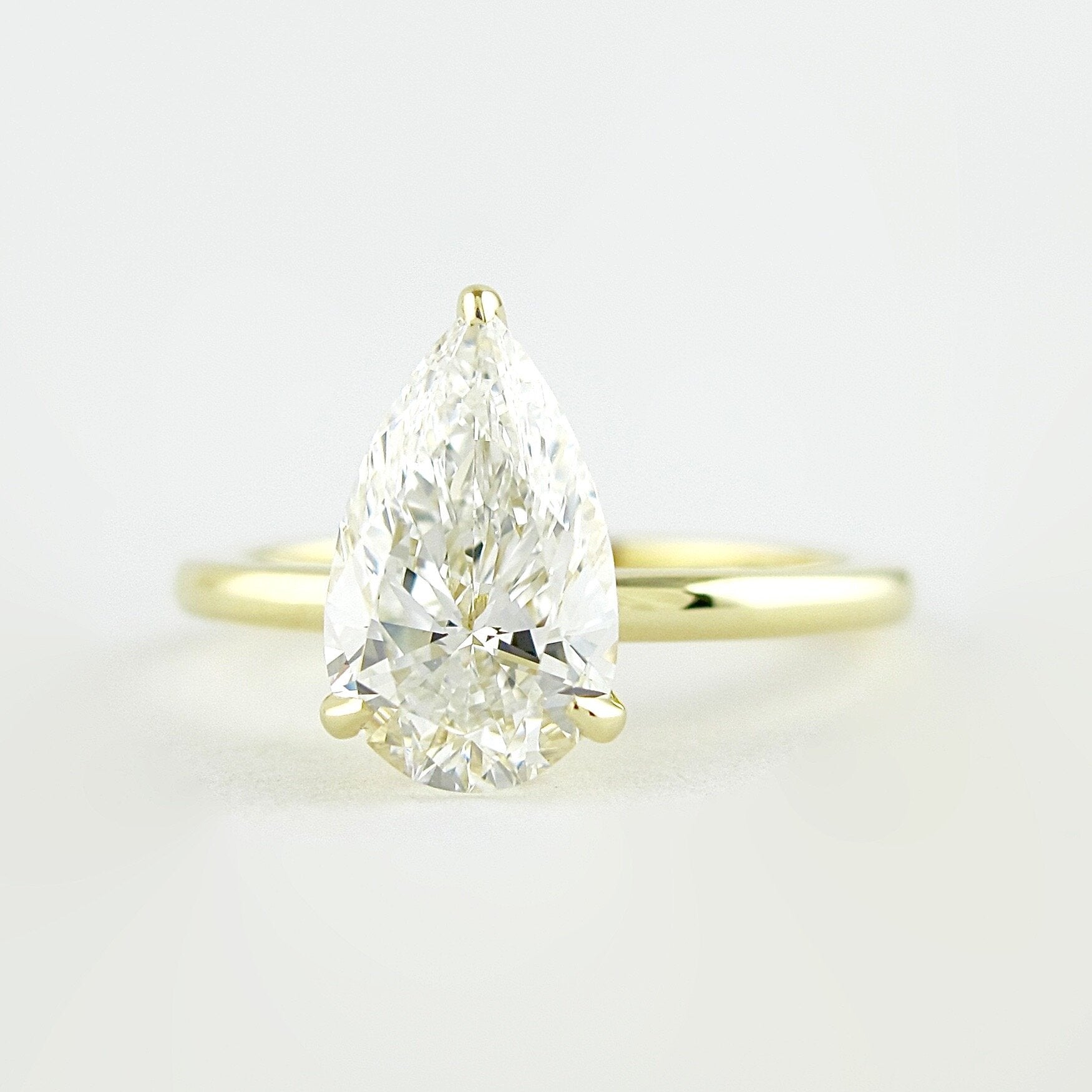 1.5 CT Pear Cut Solitaire Style Moissanite Engagement Ring 1